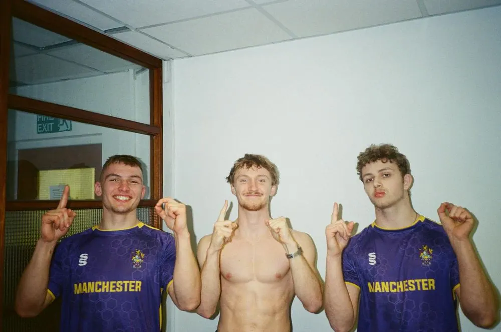 Three members in Manchester vests after a competition